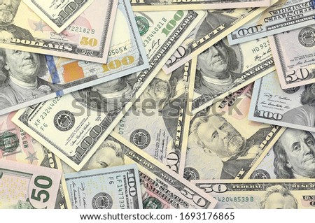 Many one hundred and fifty dollar bills on flat background surface close up. Flat lay top view