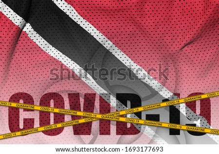 Trinidad and Tobago flag and Covid-19 inscription with orange quarantine border tape. Coronavirus or 2019-nCov virus concept