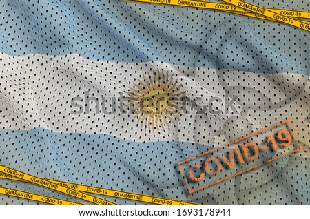 Argentina flag and Covid-19 biohazard symbol with quarantine orange tape and stamp. Coronavirus or 2019-nCov virus concept