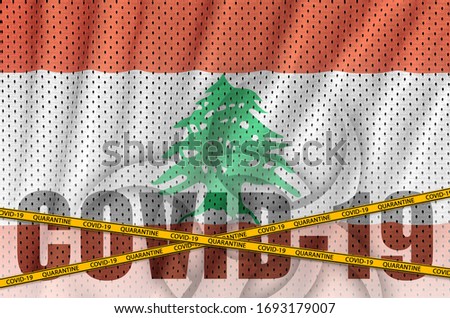Lebanon flag and Covid-19 inscription with orange quarantine border tape. Coronavirus or 2019-nCov virus concept