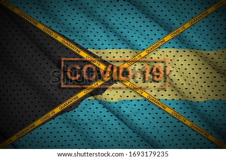 Bahamas flag and Covid-19 stamp with orange quarantine border tape cross. Coronavirus or 2019-nCov virus concept