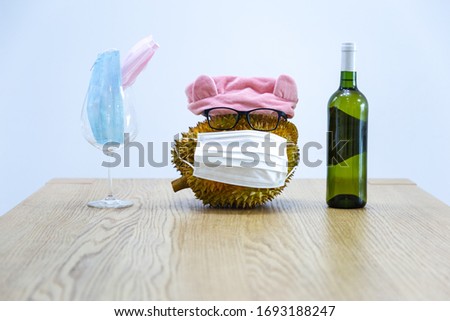 Fruit and wine glasses with disposable medical masks and wine