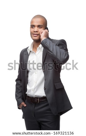 young smiling black businessman talking on cell phone isolated on white