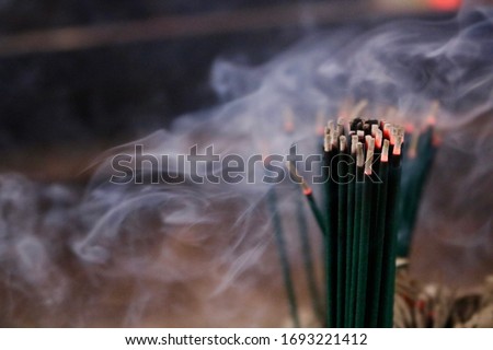 Incense stick. It called senko and candles are burned and offered on butsudans (household Buddhist altars) and at tombs when Buddhists pray for the departed souls of their ancestors. 