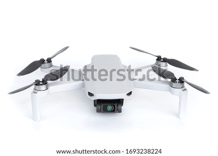light gray mini drone with a camera on a white background isolated