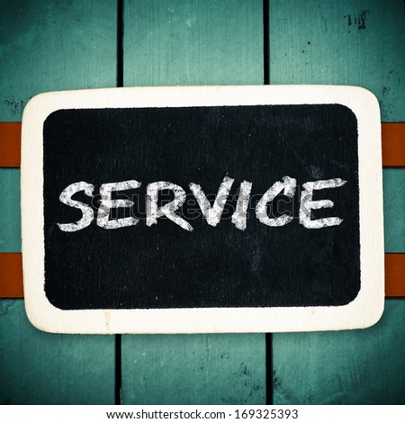 Services title written with chalk on blackboard on wood background 
