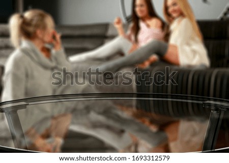 Table background of free space and home interior with woman on sofa.Copy space for your composition. 