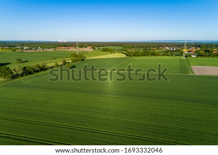 Aerial view over rural area with rape fields and green areas in Germany
