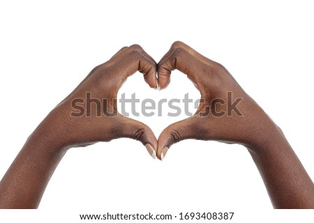 
close up hands of a young african black woman making a heart shape gesture on isolated white studio background