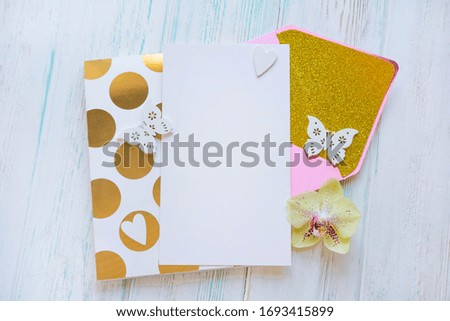 Template for an inscription with a letter envelope, notepad. White rustic background with a pink envelope and gold. Promo code distribution template
