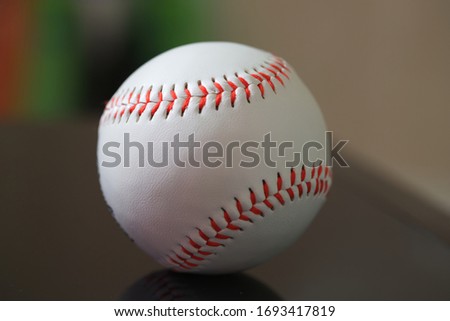 Abstract closeup image of baseball with red stitching