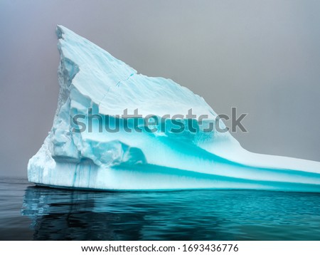 blue iceberg with steep sides in Antarctica