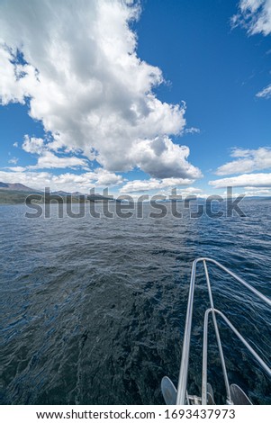 sailing boat in Antarctica, yacht navigation through icebergs and sea ice