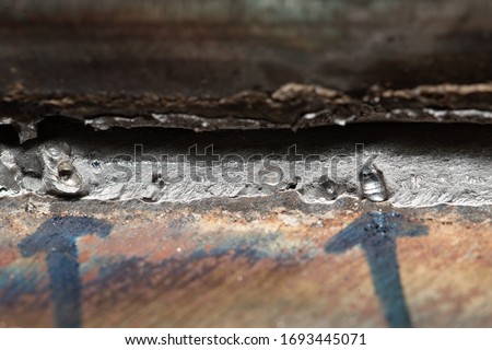 Fracture test specimen for fillet weld welder qualification, to expose welding defects on the fracture at middle grey area in photo if any, porosity appears as smooth surface and rounded in shape. Royalty-Free Stock Photo #1693445071