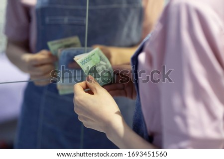 Woman counting money at home
