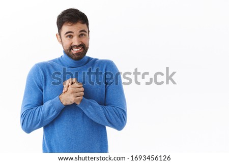 Portrait of hopeful excited bearded man clasp hands and smiling as looking at you before asking some favour, hope person can help, appreciate, standing thankful white background