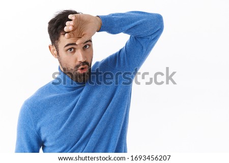 Phew that was close. Portrait of relieved handsome bearded man wiping sweat from forehead and exhale as got rid of problem, finished task, feeling exhausted, standing white background Royalty-Free Stock Photo #1693456207