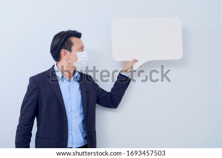 Man with mask to protect him from Corona virus. Corona virus pandemic. On bright gray background. Copy space for text.