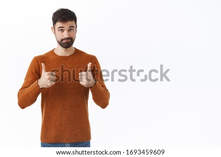 Not bad, very good result. Portrait of impressed, pleased bearded male friend encourage person, say nice job, show recommendation, thumb-up sign in approval, rate excellent choice, white background