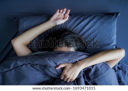 young women don't want to wake up in the morning , Top view on women sleep in the bed , Flat lay Royalty-Free Stock Photo #1693471015