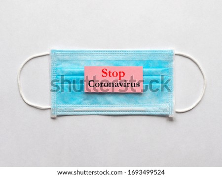 Coronavirus concept with medical mask and sign Stop Coronavirus. 