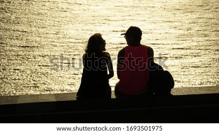 a couple are smiling during sunset at the beach
