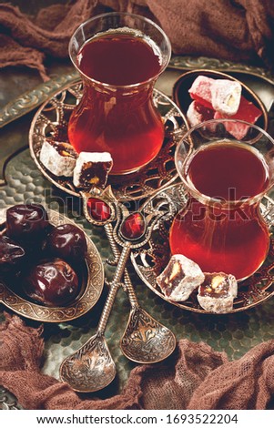 Traditional Turkish  tea served on  ornamental copper tray with glass cups, saucers  and Turkish delights