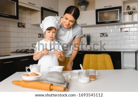 Happy family. Mother teaching her son how to cooking cake menu in morning. healthy lifestyle concept.. Baking Christmas cake and cook concept