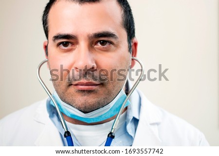 caucasian doctor with stethoscope portrait on a white background.