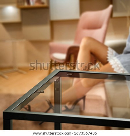 Table background of free space and home interior with woman legs 
