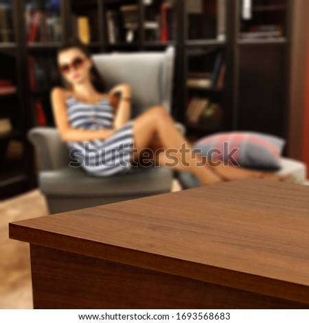 desk of free space and home interior with woman on sofa 