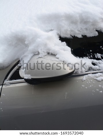 a part of a car covered by the snow
