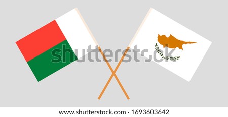 Crossed flags of Madagascar and Cyprus. Official colors. Correct proportion. Vector illustration
