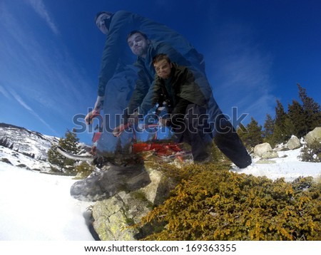 man jumping from rock with sled high motion abstract picture