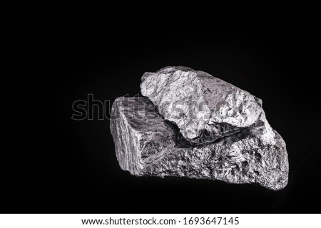 small titanium stone, metal used in light alloys. Macro photography of rough ore. Royalty-Free Stock Photo #1693647145
