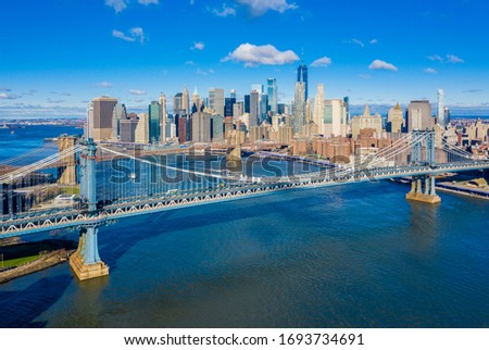 New York City skyline with Manhattan and Brooklyn Bridges along the East River from DUMBO