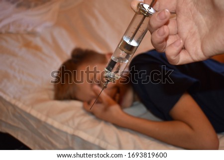 Vaccination of the child. Big scary syringe. Frightening doctor . Mandatory vaccination of children. no vaccinatie