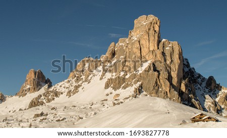 The Giau Pass (2236 m) in the Dolomites in Italy, located at the foot of Nuvolau (2,574 m) and dell'Averau (2,647 m). And at the corner of the picture the restaurant Malga Giau