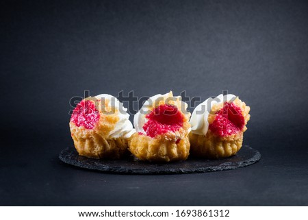 Cakes on black background isolated with fruits close up