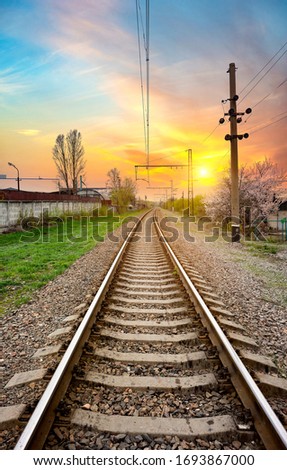 Electric poles on a railway station at sunrise