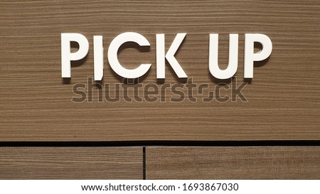 Sign pick up here on wooden in coffee shop