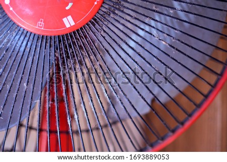 close up the dust on the cover of the red fan