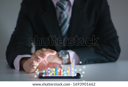 Business man show financial stock growth concept technology and graph display on smartphone