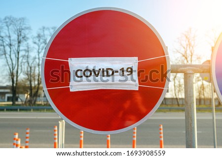 no entry road sign and medical mask with inscription covid-19. coronavirus quarantine zone or isolation period concept.
