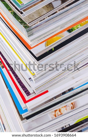 Closeup background of a pile of magazines. Design concept. Selective focus.