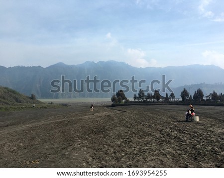 View of the valley around the Mt Bromo volcano where you can see local offering rides with donkeys