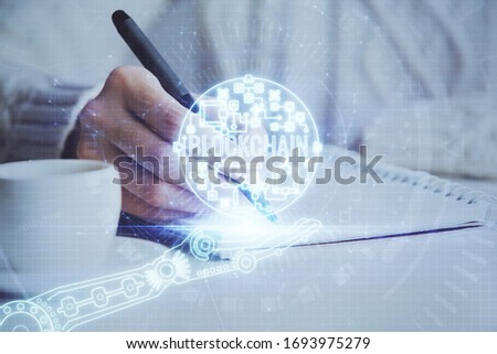 Cryptocurrency hologram over hands taking notes background. Concept of blockchain. Multi exposure