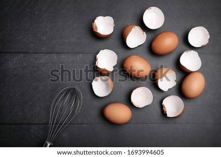 Mock-up of many eggs on the table for cooking. Baking ingredients on wooden table. Space for text.