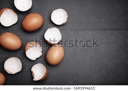 Mock-up of many eggs on the table for cooking. Baking ingredients on wooden table. Space for text.
