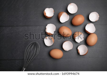 Many eggs on the table for cooking. Baking ingredients on wooden table.